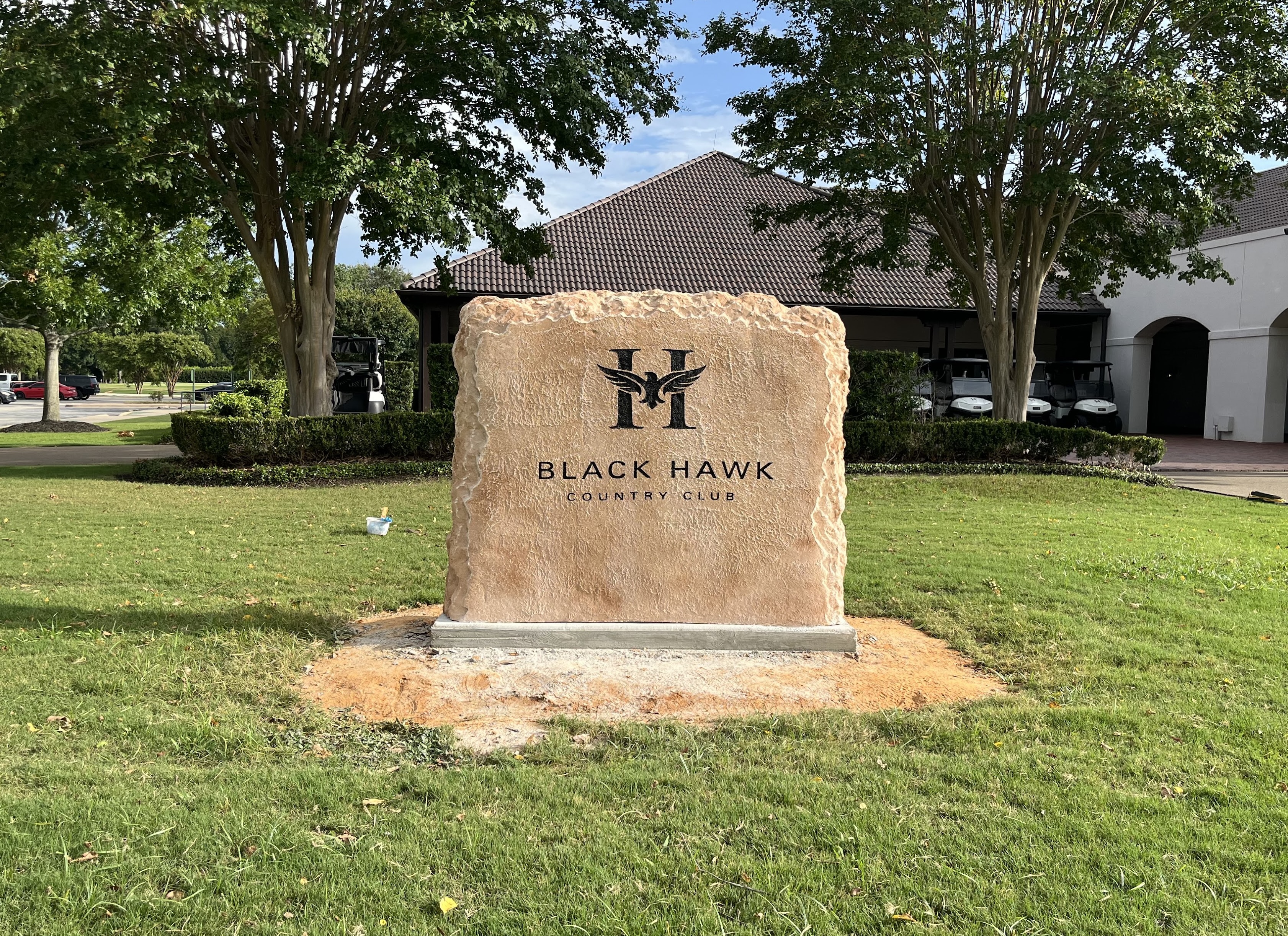 Custom commercial sign made of engineered stone in Houston by Bedrock Boulders.