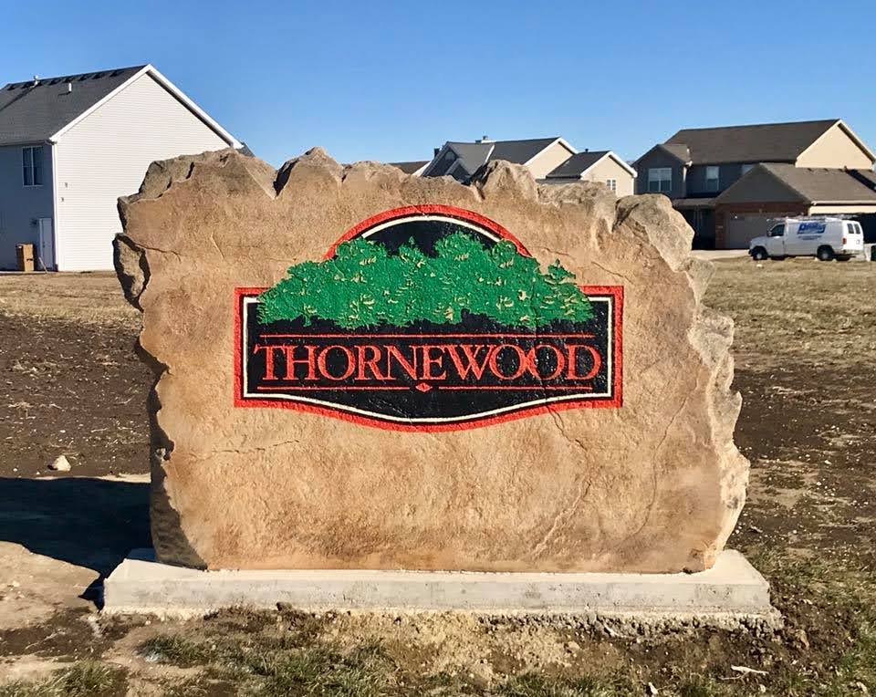 Custom commercial sign made of engineered stone in Houston by Bedrock Boulders.