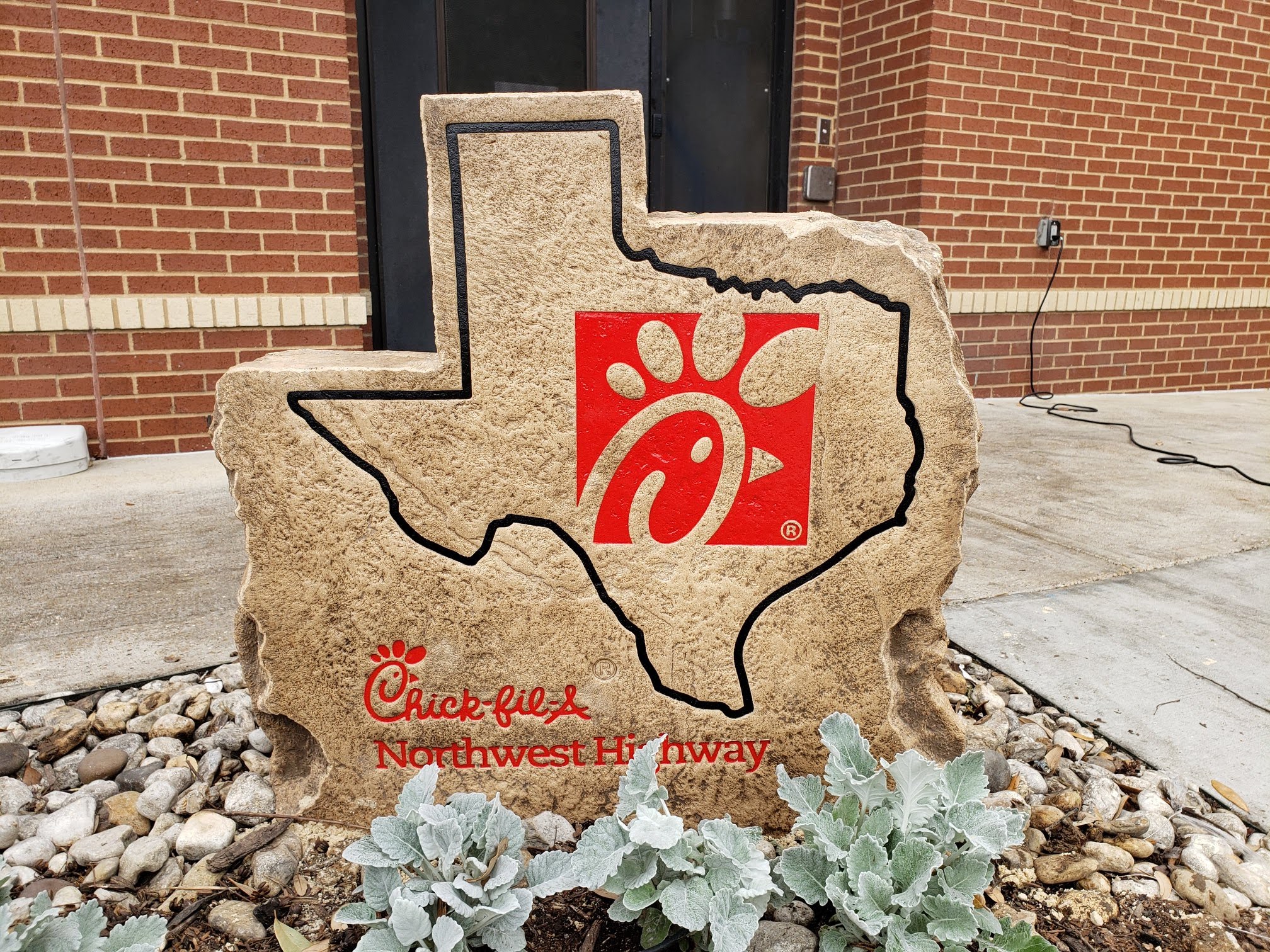 Custom commercial sign made of engineered stone in Houston by Bedrock Boulders.