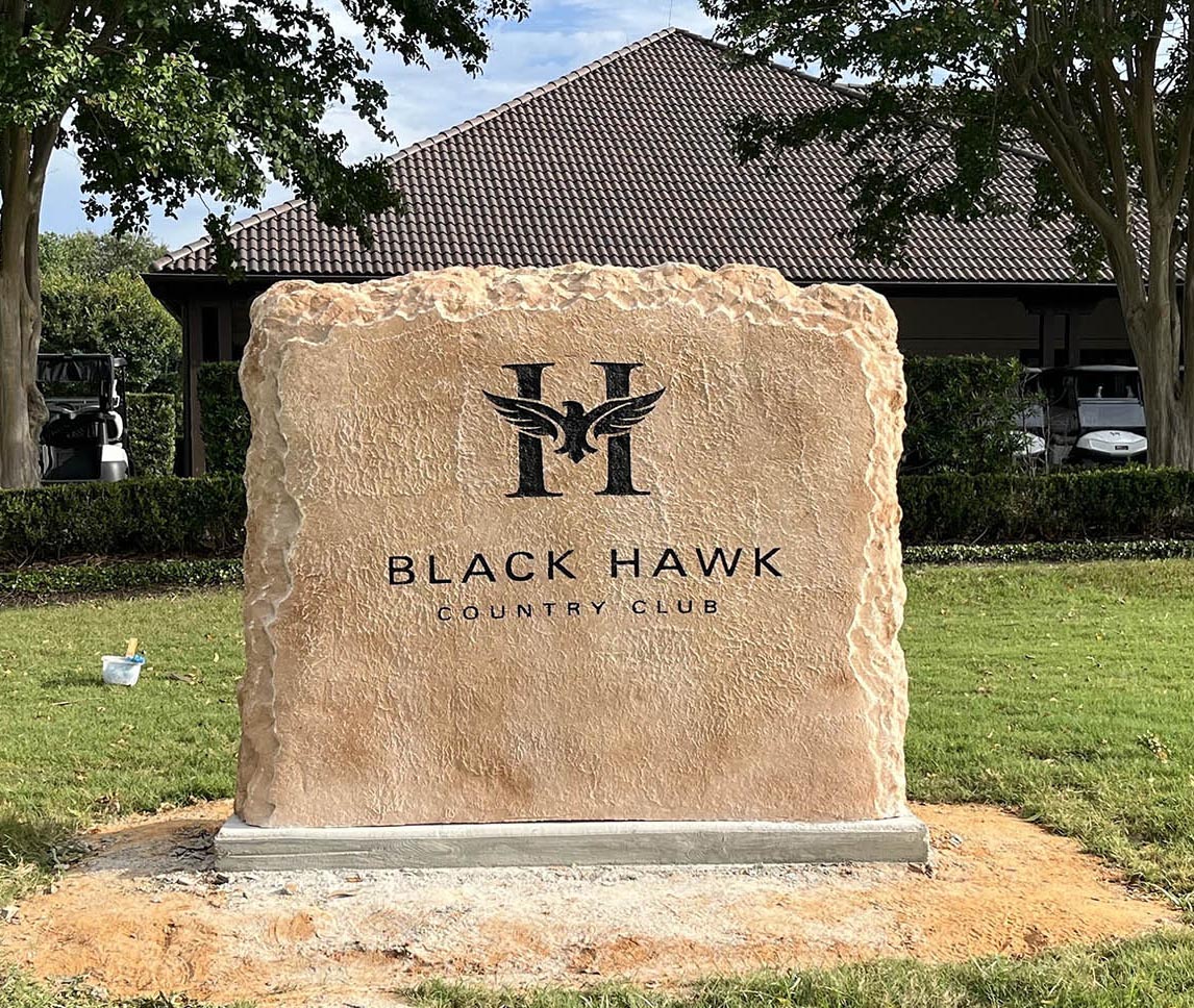 Custom commercial sign made of engineered stone in Houston by Bedrock Boulders