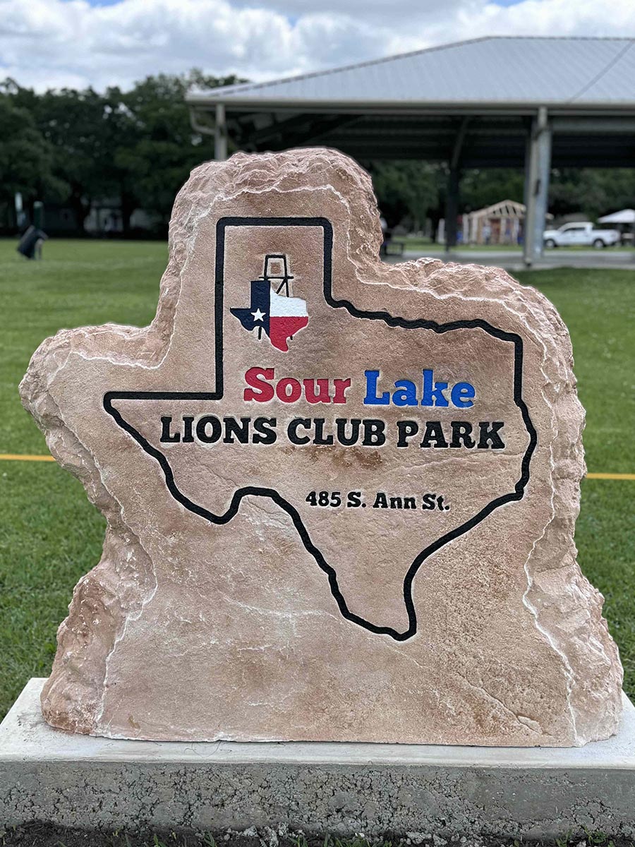 Custom commercial sign made of engineered stone in Houston by Bedrock Boulders