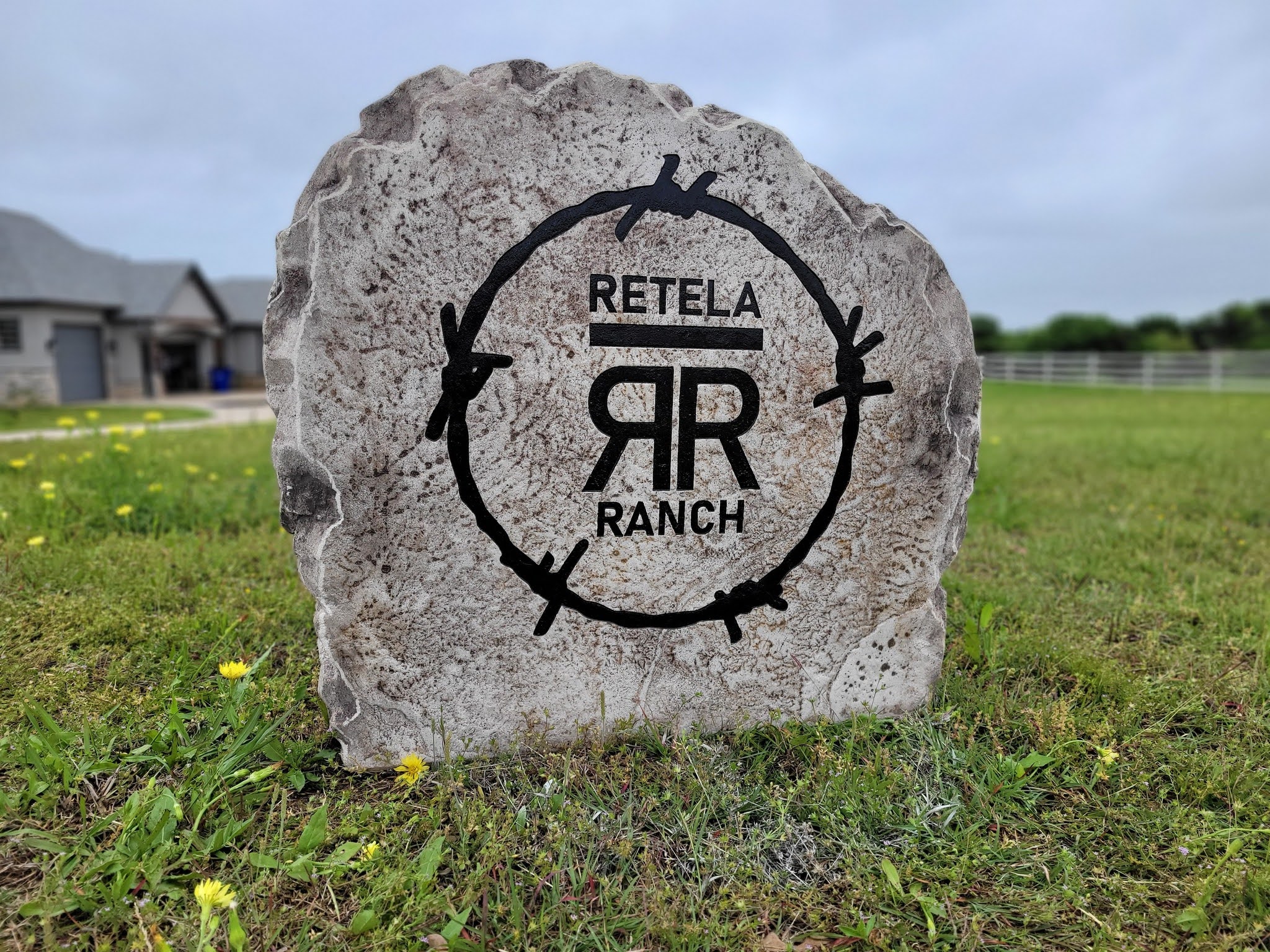 Custom ranch sign made of engineered stone in Houston by Bedrock Boulders.